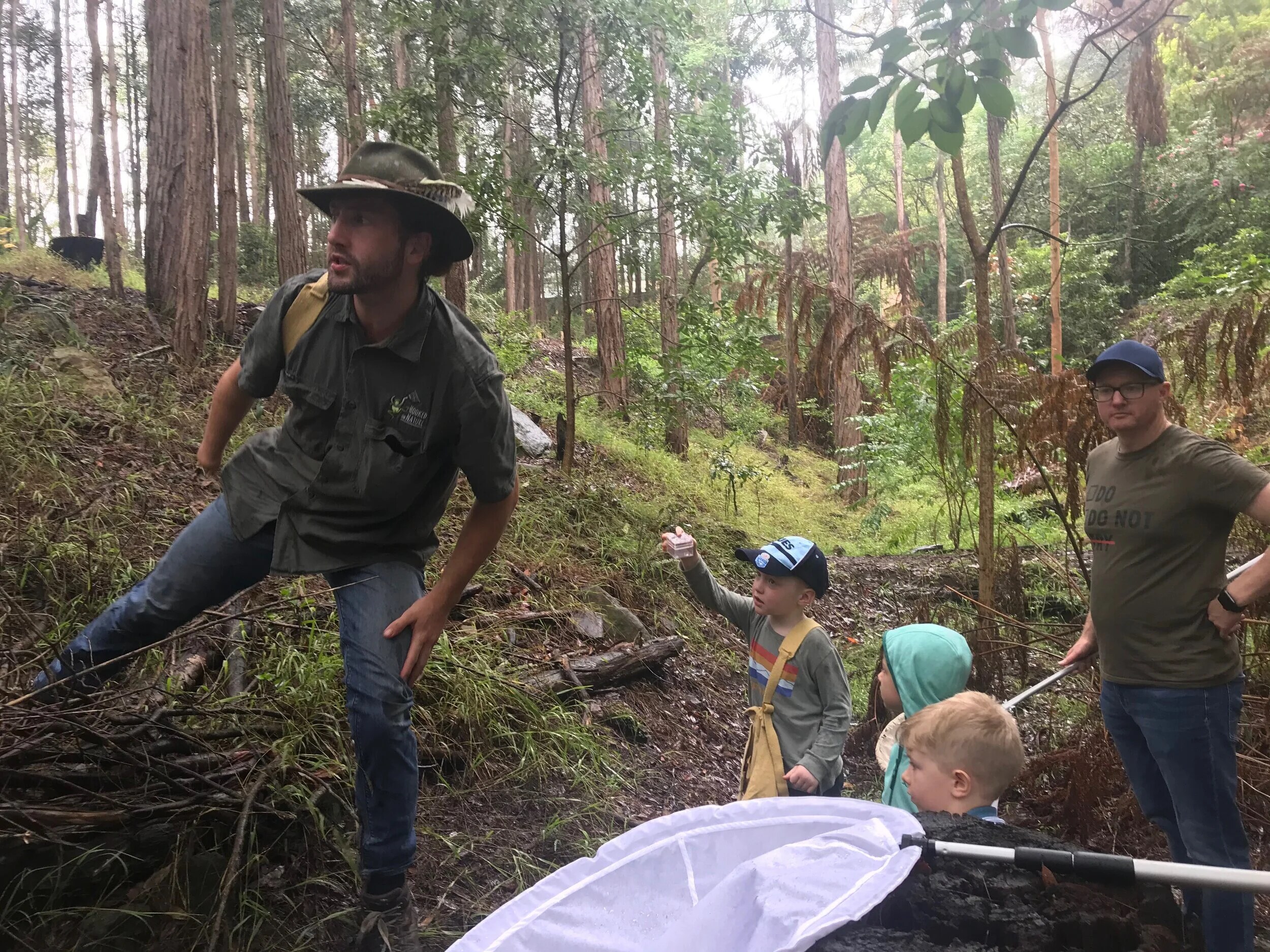 Kids on a bug hunt in the forest with Tom